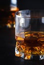 Bourbon in glass, american corn whiskey, dark bar counter, selective focus