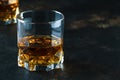 Bourbon in glass, american corn whiskey, dark bar counter, selective focus