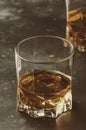 Bourbon in glass, american corn whiskey, dark bar counter, selective focus