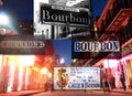 Bourbon St in New Orleans at night with collage of street signs and markers Royalty Free Stock Photo