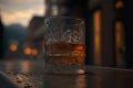 Bourbon or whisky glass on dark woody background, close up