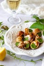 Bourguignonne snail with lemon. Marble background. French cuisine. Royalty Free Stock Photo