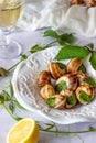 Bourguignonne snail with lemon. Marble background. French cuisine Royalty Free Stock Photo