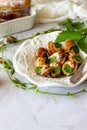 Bourguignonne snail with lemon. Marble background. French cuisine Royalty Free Stock Photo