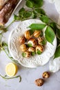 Bourguignonne snail with lemon. Marble background. French cuisine Royalty Free Stock Photo