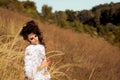 Pretty girl held cones in hands and sit in field Royalty Free Stock Photo