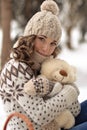 Very cute, lovely, beautiful, attractive, gorgeous girl with curly, wavy hair hug a teddy bear. Cute little girl with toy, white, Royalty Free Stock Photo