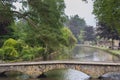 Stone footbridge across the River Windrush in Bourton-on-the-Water, also known as The Venice of the Cotswolds - Gloucestershire - Royalty Free Stock Photo