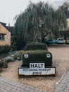 Car made out of hedge with a sign showing the entrance to the Halt Motoring Museum