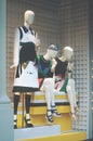 Boutique fashion display window with a dressed mannequin and bla