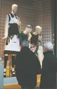 Boutique fashion display window with dressed mannequin in modern