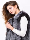 Boutique selling fur. Girl makeup face long hairstyle wear fur vest white background. Luxury fur accessory. Fashion