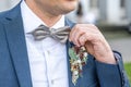 boutonniere flower groom wedding outfit coat with bow-tie Royalty Free Stock Photo