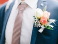 Boutonniere flower on suit jacket of wedding groom Royalty Free Stock Photo