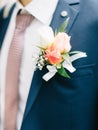 Boutonniere flower on suit jacket of wedding groom Royalty Free Stock Photo