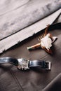 Boutonniere and a men watch lie on the groom suit