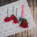 Boutonniere and pins with a red rose Royalty Free Stock Photo