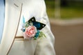 Boutonniere of Rose on a White Fashionable Wedding Suit of Groom at Sunny Day Outdoors Royalty Free Stock Photo