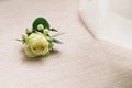 Boutonniere on a wooden floor. Wedding accessories. Bride's preparations. Wedding morning concept.