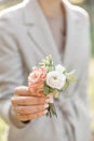 Boutonniere. Young girl holding a beautiful spring Flowers. flower arrangement with lisianthus. Color light pink. Bright