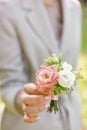 Boutonniere. Young girl holding a beautiful spring Flowers. flower arrangement with lisianthus. Color light pink. Bright