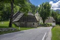 Bovec, Trenta Valley, Slovenia - July 6, 2022: picturesque houses with old Lady of Loreto Church surrounded with greenery