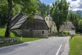 Bovec, Trenta Valley, Slovenia - July 6, 2022: picturesque houses with old Lady of Loreto Church surrounded with greenery