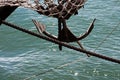 Bow of a black sailing yacht against the blue sea with anchor at the bow. copy space, selective focus, narrow depth of field. Royalty Free Stock Photo