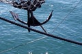 Bow of a black sailing yacht against the blue sea with anchor at the bow. copy space, selective focus, narrow depth of field. Royalty Free Stock Photo