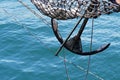 Bow of a black sailing yacht against the blue sea with anchor at the bow. copy space, selective focus, narrow depth of field. Royalty Free Stock Photo