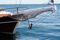 Bow of a black sailing yacht against the blue sea with anchor at the bow. copy space, selective focus, narrow depth of field Royalty Free Stock Photo