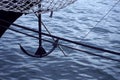 Bow of a black sailing yacht against the blue sea with anchor at the bow. copy space, selective focus, narrow depth of field Royalty Free Stock Photo