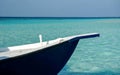 Bow of a blue and white wooden boat on turquoise water sea Royalty Free Stock Photo