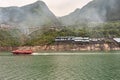 Bow bridge and red speed ferry in Xiling Region on Yangtze River, China