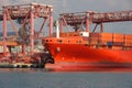 Bow of a container ship moored in the calm channel of the port of Genoa