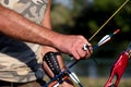 Bow hunter hands holding compound bow