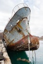 Bow of an old abandoned ship hangs over the sea Royalty Free Stock Photo