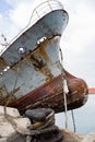 Bow of an old abandoned ship hangs over the sea Royalty Free Stock Photo