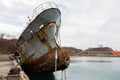 Bow of an old abandoned ship hangs over the sea Royalty Free Stock Photo