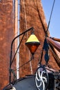 The bow of an old flat-bottomed boat with buoy and anchorwinch with in the background the brown sails of a traditional Dutch Royalty Free Stock Photo