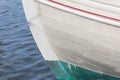 Bow of an old wooden boat, white green and red paint, copy space Royalty Free Stock Photo