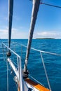 A bow pulpit, a yacht getting close to the Green Island in Great Coral Barrier, Cairns, Australia