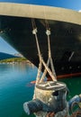 Bow, rat guards and mooring lines of cruise ship tied to dock bollard,, Alaska. Royalty Free Stock Photo