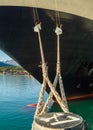 Bow, rat guards and mooring lines of cruise ship tied to dock bollard,, Alaska. Royalty Free Stock Photo