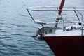 Bow of a red sailing yacht against the blue sea with anchor at the bow. copy space, selective focus, narrow depth of field Royalty Free Stock Photo