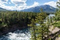 Bow River and Bow Falls in summer sunny day, Mount Norquay in the background. Banff National Park Royalty Free Stock Photo