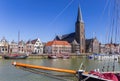 Bow of a sailing ship and church tower in Harlingen Royalty Free Stock Photo