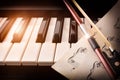 Bow with sheet music on piano keys front Royalty Free Stock Photo
