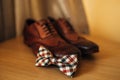 Bow tie and brown shoes Royalty Free Stock Photo