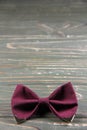 Bow tie coloring Marsala on a wooden background